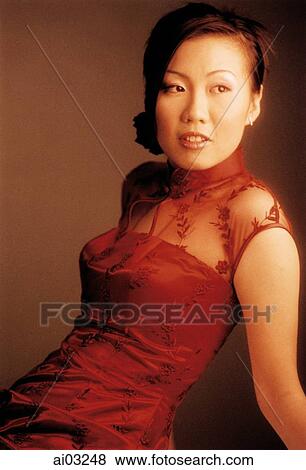 Woman in red dress looking away. View Large Photo Image Stock Photo - Woman in red dress looking away.. Fotosearch