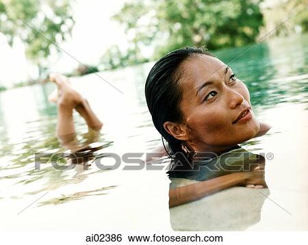 Woman in water, looking off camera. View Large Photo Image Stock Photograph - Woman in water, looking off camera.. Fotosearch