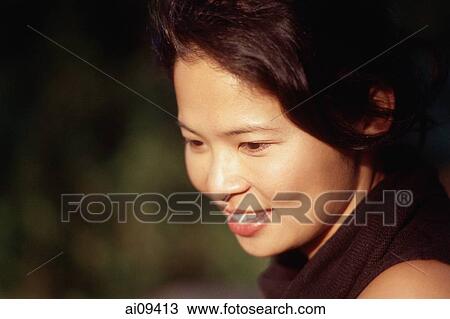 Woman looking down and smiling View Large Photo Image Stock Image - Woman looking down and smiling. Fotosearch