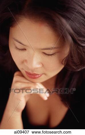 Woman looking down, chin on hand View Large Photo Image Stock Photo - Woman looking down, chin on hand. Fotosearch