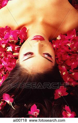 Woman lying amongst flowers View Large Photo Image Stock Photo - Woman lying amongst flowers. Fotosearch