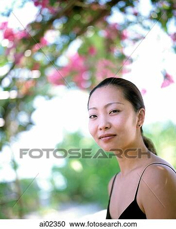 Woman outdoors, trees in background, portrait View Large Photo Image Stock Image - Woman outdoors, trees in background, portrait. Fotosearch