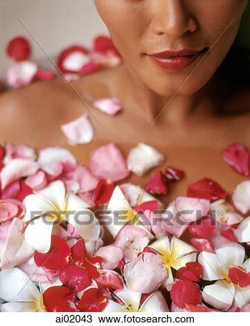 Woman relaxing in bathtub with flower petals View Large Photo Image Stock Image - Woman relaxing in bathtub with flower petals. Fotosearch