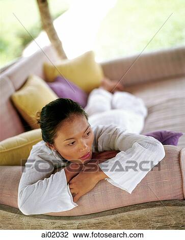 Woman relaxing on sofa outdoors View Large Photo Image Stock Image - Woman relaxing on sofa outdoors. Fotosearch