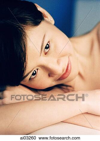 Woman resting head on hands, smiling View Large Photo Image Stock Image - Woman resting head on hands, smiling. Fotosearch