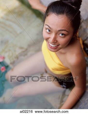 Woman sitting in swimming pool, portrait, smiling View Large Photo Image Stock Photograph - Woman sitting in swimming pool, portrait, smiling. Fotosearch
