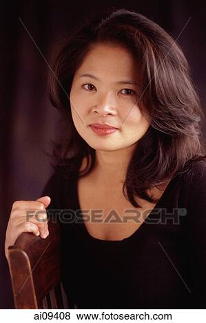 Woman sitting looking at camera View Large Photo Image Stock Photo - Woman sitting looking at camera. Fotosearch