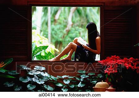 Woman sitting on window ledge, reading View Large Photo Image Picture - Woman sitting on window ledge, reading. Fotosearch