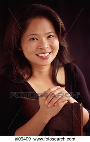 Woman smiling and sitting View Large Photo Image Stock Photo - Woman smiling and sitting. Fotosearch