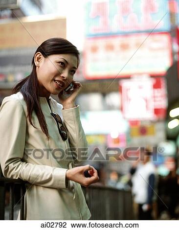 Woman using cellular phone in busy street. View Large Photo Image Stock Image - Woman using cellular phone in busy street.. Fotosearch