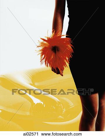 Woman wearing red feather around wrist, yellow inflatable chair behind View Large Photo Image Stock Image - Woman wearing red feather around wrist, yellow inflatable chair behind. Fotosearch