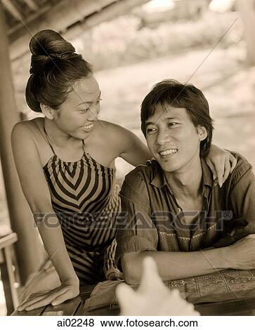Woman with arm around man, at table View Large Photo Image Stock Photo - Woman with arm around man, at table. Fotosearch