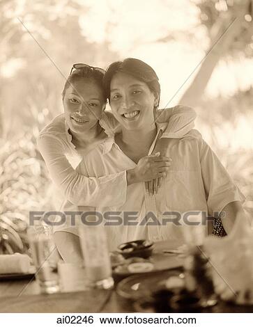 Woman with arm around man, at table View Large Photo Image Stock Photograph - Woman with arm around man, at table. Fotosearch