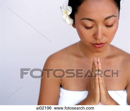 Woman with flower in hair, palms raised, white background View Large Photo Image Stock Photograph - Woman with flower in hair, palms raised, white background. Fotosearch
