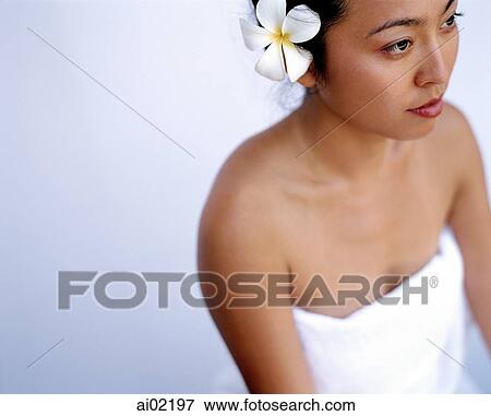 Woman with flower in hair, white background View Large Photo Image Stock Photo - Woman with flower in hair, white background. Fotosearch