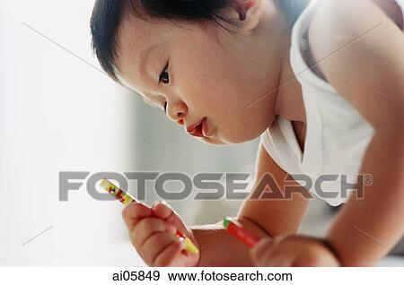 Young boy holding crayons View Large Photo Image Stock Photo - Young boy holding crayons. Fotosearch