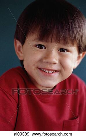 Stock Photo - Young boy looking at camera and smiling. Fotosearch