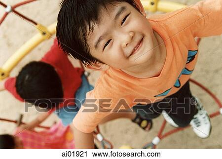 Young boy playing in jungle gym, elevated view View Large Photo Image Stock Image - Young boy playing in jungle gym, elevated view. Fotosearch