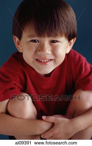 Young boy sitting with arms around his knees View Large Photo Image Stock Image - Young boy sitting with arms around his knees. Fotosearch