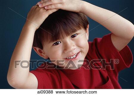 Young boy smiling with hands on head View Large Photo Image Stock Photo - Young boy smiling with hands on head. Fotosearch