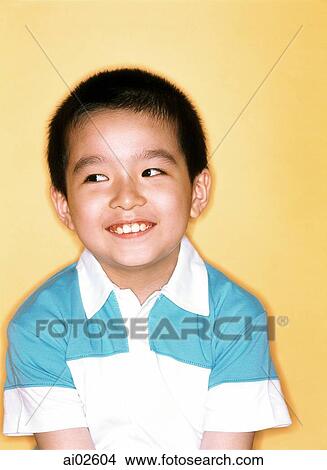 Young boy smiling, yellow background. View Large Photo Image Picture - Young boy smiling, yellow background.. Fotosearch