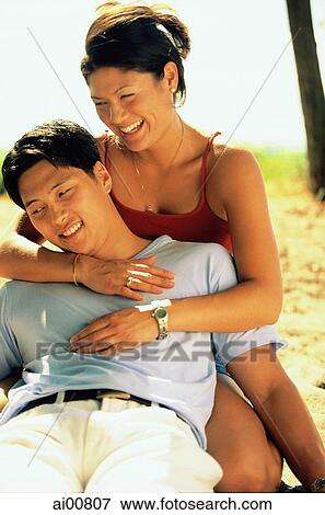 Young couple embracing outdoors View Large Photo Image Stock Photo - Young couple embracing outdoors. Fotosearch