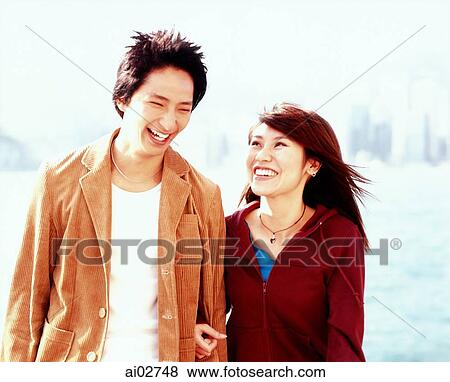 Young couple laughing, city skyline behind. View Large Photo Image Stock Photo - Young couple laughing, city skyline behind.. Fotosearch