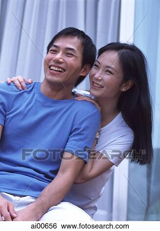 Young couple laughing, in embrace View Large Photo Image Stock Photograph - Young couple laughing, in embrace. Fotosearch