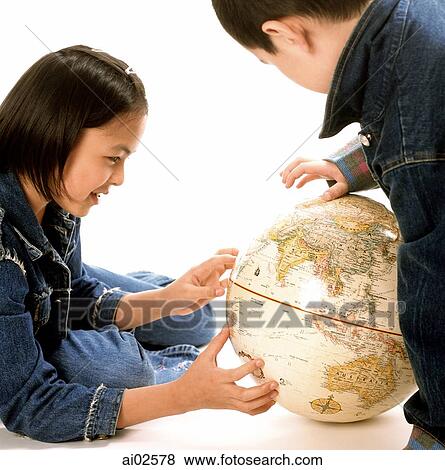 Young girl and boy looking at globe, Asia prominent. View Large Photo Image Stock Photo - Young girl and boy looking at globe, Asia prominent.. Fotosearch