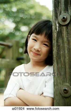 Young girl leaning on pillar, View Large Photo Image Picture - Young girl leaning on pillar,. Fotosearch