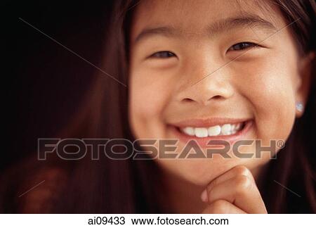 Young girl smiling with hand on chin, toothy smile View Large Photo Image Stock Image - Young girl smiling with hand on chin, toothy smile. Fotosearch