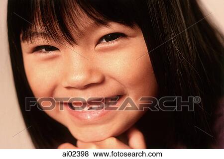 Young girl with chin on hand, smiling, portrait View Large Photo Image Stock Photo - Young girl with chin on hand, smiling, portrait. Fotosearch