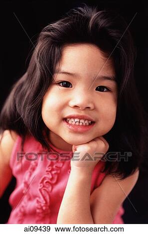 Young girl with hand on chin, toothy smile View Large Photo Image Stock Photo - Young girl with hand on chin, toothy smile. Fotosearch