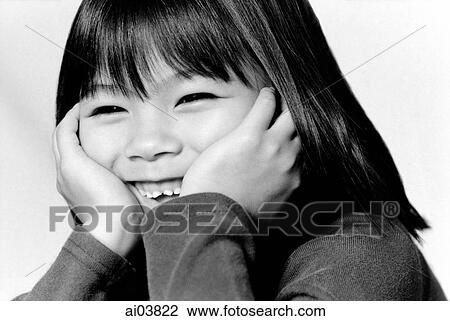 Stock Image - Young girl with hands on head, laughing. Fotosearch