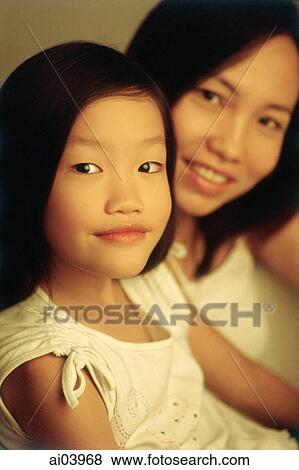 Young girl with mother in background, portrait View Large Photo Image Stock Photo - Young girl with mother in background, portrait. Fotosearch