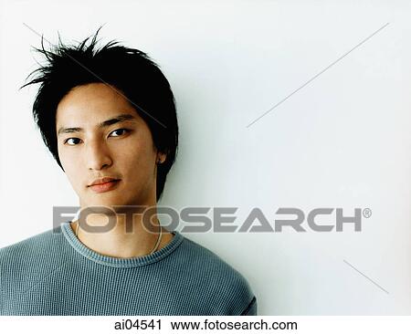 Young man against white background, portrait. View Large Photo Image Stock Image - Young man against white background, portrait.. Fotosearch