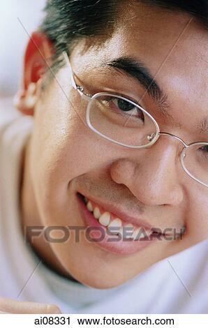 Young man in spectacles, smiling. View Large Photo Image Stock Image - Young man in spectacles, smiling.. Fotosearch