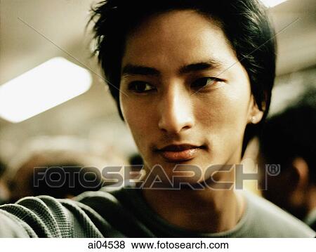 Young man looking off camera. View Large Photo Image Stock Photo - Young man looking off camera.. Fotosearch