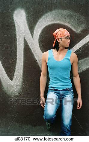 Young man wearing orange bandana and sunglasses View Large Photo Image Stock Image - Young man wearing orange bandana and sunglasses. Fotosearch