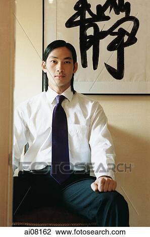 Young man wearing white shirt and tie, sitting. View Large Photo Image Stock Image - Young man wearing white shirt and tie, sitting.. Fotosearch
