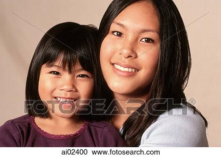 Stock Image - Young woman and young girl, portrait. Fotosearch
