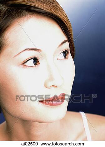 Young woman, blue background, portrait View Large Photo Image Stock Image - Young woman, blue background, portrait. Fotosearch