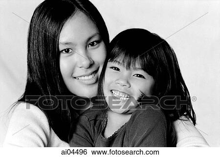 Young woman hugging young girl View Large Photo Image Stock Photograph - Young woman hugging young girl. Fotosearch