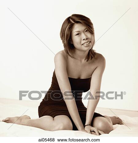 Young woman in black dress sitting, portrait View Large Photo Image Stock Photo - Young woman in black dress sitting, portrait. Fotosearch