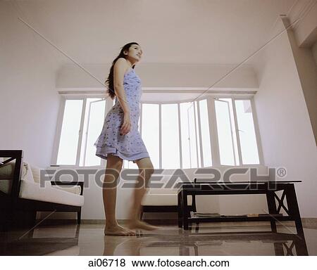 Young woman in living room. View Large Photo Image Stock Photo - Young woman in living room.. Fotosearch