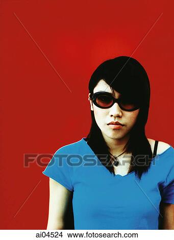 Young woman in sunglasses, red background. View Large Photo Image Picture - Young woman in sunglasses, red background.. Fotosearch