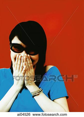 Young woman in sunglasses with hands covering mouth, red background. View Large Photo Image Stock Photograph - Young woman in sunglasses with hands covering mouth, red background.. Fotosearch