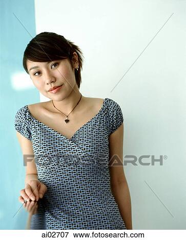 Young woman leaning against railing, portrait. View Large Photo Image Stock Photo - Young woman leaning against railing, portrait.. Fotosearch