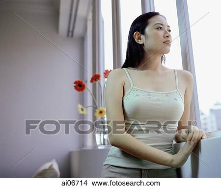 Young woman looking out of window. View Large Photo Image Picture - Young woman looking out of window.. Fotosearch