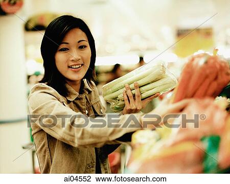 Young woman shopping for produce, portrait. View Large Photo Image Stock Image - Young woman shopping for produce, portrait.. Fotosearch